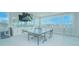 Spacious game room features a large mounted TV, ping pong table, and bright, window-filled space at 13779 Abberwick Dr, Orlando, FL 32832