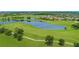 Scenic golf course featuring a serene lake, a walking path, and verdant green landscapes at 13779 Abberwick Dr, Orlando, FL 32832