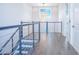 Bright hallway featuring a chandelier, modern railings, and sleek flooring at 13779 Abberwick Dr, Orlando, FL 32832