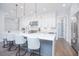 Bright kitchen boasts white cabinetry, stainless steel appliances, a large island, pendant lights, and a walk-in pantry at 13779 Abberwick Dr, Orlando, FL 32832