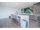 A living area is equipped with a wet bar and stools adjacent to a large table at 13779 Abberwick Dr, Orlando, FL 32832