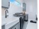 Functional laundry room with modern appliances, a utility sink, and ample storage space at 13779 Abberwick Dr, Orlando, FL 32832