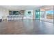 A large living area is equipped with a wet bar, stools, a pool table, and access to a patio at 13779 Abberwick Dr, Orlando, FL 32832