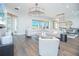 A bright, stylish living room showcases modern decor, hardwood floors, and large windows offering scenic views and ample natural light at 13779 Abberwick Dr, Orlando, FL 32832
