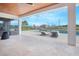 A covered patio with lounge chairs overlooking a sparkling pool, providing a relaxing outdoor living space at 13779 Abberwick Dr, Orlando, FL 32832