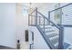 Elegant staircase with a statement chandelier, modern railings, and a view of the entry at 13779 Abberwick Dr, Orlando, FL 32832