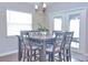 Bright dining area with a square table and six chairs, adjacent to sliding glass doors at 229 Talladega Ln, Polk City, FL 33868