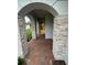 Inviting front entry with stone columns and brick pavers at 3185 Songbird Cir, Harmony, FL 34773