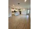 Open concept kitchen with island and light wood floors at 3185 Songbird Cir, Harmony, FL 34773