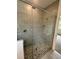 Walk-in shower with pebble floor and glass enclosure at 3185 Songbird Cir, Harmony, FL 34773