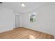 Simple bedroom with light wood flooring and a window at 514 S 7Th St, Lake Wales, FL 33853