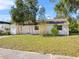 Charming single-story home with a well-manicured front lawn and mature trees at 514 S 7Th St, Lake Wales, FL 33853