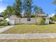 Charming single-story home with a well-maintained lawn and mature trees providing shade at 514 S 7Th St, Lake Wales, FL 33853