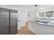 Charming white kitchen with granite countertops and stainless steel refrigerator at 514 S 7Th St, Lake Wales, FL 33853