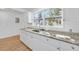 The remodeled kitchen features modern finishes, granite counters, stainless sink, new cabinets, and sleek appliances at 514 S 7Th St, Lake Wales, FL 33853