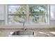 This kitchen view displays sparkling granite countertops and a stainless steel sink beneath a window with a neighborhood view at 514 S 7Th St, Lake Wales, FL 33853