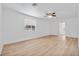 Bright living room with wood-look floors, ceiling fan and large window at 514 S 7Th St, Lake Wales, FL 33853