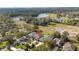 Aerial view of the property showcasing its location, surrounding landscape, and nearby lake at 7 Huntley Ct., Haines City, FL 33844