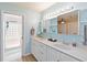 Double vanity bathroom with light blue walls and a shower at 7 Huntley Ct., Haines City, FL 33844