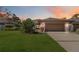 Inviting home exterior with landscaped lawn and attached garage at 7 Huntley Ct., Haines City, FL 33844