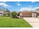 Charming single-story home with well-manicured lawn, mature landscaping, and a two-car garage at 7 Huntley Ct., Haines City, FL 33844