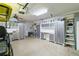 Organized garage space with ample storage cabinets and workspace with overhead lighting at 7 Huntley Ct., Haines City, FL 33844