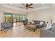Living room with hardwood floors, comfortable seating and access to a screened lanai at 7 Huntley Ct., Haines City, FL 33844