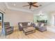 Bright living room with hardwood floors, comfortable seating, and large windows at 7 Huntley Ct., Haines City, FL 33844