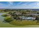 Aerial view of the community, pool, and clubhouse on a lake at 9143 Sw 65Th Loop, Ocala, FL 34481