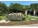 Stone Creek entrance with a beautiful waterfall feature and manicured landscaping at 9143 Sw 65Th Loop, Ocala, FL 34481