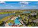 Aerial view of a resort-style pool surrounded by lush landscaping and palm trees at 9143 Sw 65Th Loop, Ocala, FL 34481
