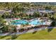 Beautiful aerial view of the community pool with ample seating and palm trees at 9143 Sw 65Th Loop, Ocala, FL 34481