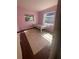 Cozy bedroom showcasing hardwood floors, two windows, and a twin bed frame at 116 Main St, Windermere, FL 34786