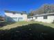 Back exterior view showcasing the large lawn and the exterior building at 116 Main St, Windermere, FL 34786