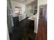 Efficient kitchen with white cabinets, black appliances, and a breakfast bar for casual dining at 116 Main St, Windermere, FL 34786