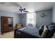 Blue bedroom with a queen-size bed and wooden dresser at 2570 Oak St, Kissimmee, FL 34744