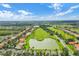 A breathtaking aerial view showcasing a golf course community with lush landscaping, serene lakes, and beautiful homes at 2806 Balforn Tower Way, Winter Garden, FL 34787