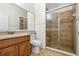 Modern bathroom with a vanity, toilet, and a shower stall with tiled walls and glass door at 2806 Balforn Tower Way, Winter Garden, FL 34787