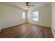 Bedroom features windows for natural light, ceiling fan, and hardwood floors at 2806 Balforn Tower Way, Winter Garden, FL 34787