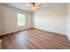 Bedroom features a window for natural light, ceiling fan and hardwood floors at 2806 Balforn Tower Way, Winter Garden, FL 34787