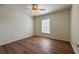 Bedroom features a window for natural light, ceiling fan and hardwood floors at 2806 Balforn Tower Way, Winter Garden, FL 34787