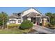 Stonesbrook West Town Center clubhouse featuring gray roofing, stone pillars and meticulously maintained landscaping at 2806 Balforn Tower Way, Winter Garden, FL 34787