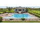 A beautiful community pool and clubhouse area with ample seating and manicured landscaping at 2806 Balforn Tower Way, Winter Garden, FL 34787