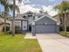 Charming two-story home features a two-car garage, lush landscaping, and a freshly painted exterior at 2806 Balforn Tower Way, Winter Garden, FL 34787