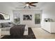 The main bedroom is light and bright with artwork, ceiling fan, and large windows at 2806 Balforn Tower Way, Winter Garden, FL 34787