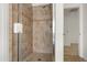 Modern bathroom shower with clear glass doors and attractive brown tile surround at 2806 Balforn Tower Way, Winter Garden, FL 34787