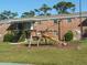 The exterior of a brick building with stairs, slide, and playground equipment at 5317 Curry Ford Rd # J101, Orlando, FL 32812