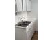 Efficient kitchen featuring white cabinets and a double sink at 5317 Curry Ford Rd # J101, Orlando, FL 32812