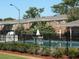 The fenced in community pool is lined with shrubbery and trees at 5317 Curry Ford Rd # J101, Orlando, FL 32812