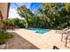 Relaxing pool area with patio and lounge chairs, surrounded by lush landscaping at 710 Kellys Cv, Ocoee, FL 34761